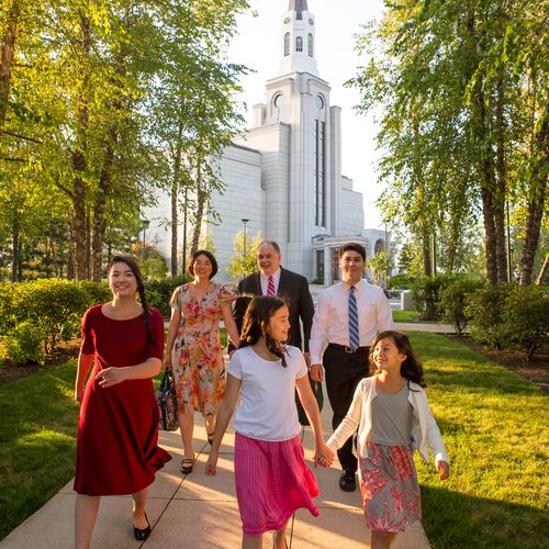 A family walking together toward a temple